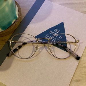 gold rim round glasses